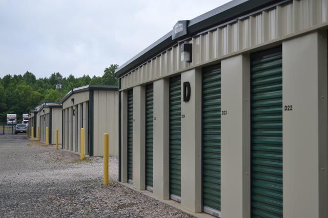 A row of storage units with green doors.